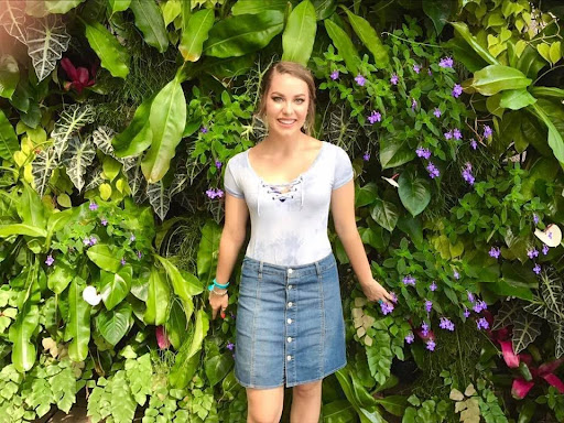 Photo of Jordan in front of green plants